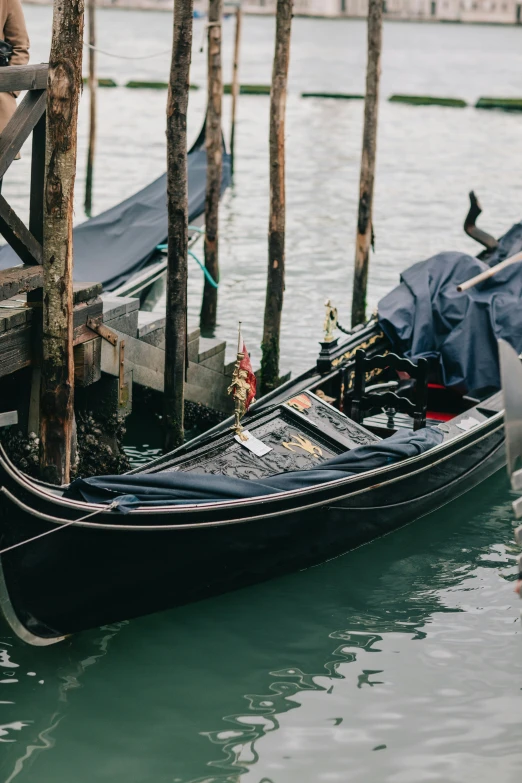 the couple is sitting on their gondola in front of the dock