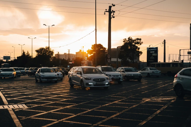 traffic in an intersection is busy with the sun