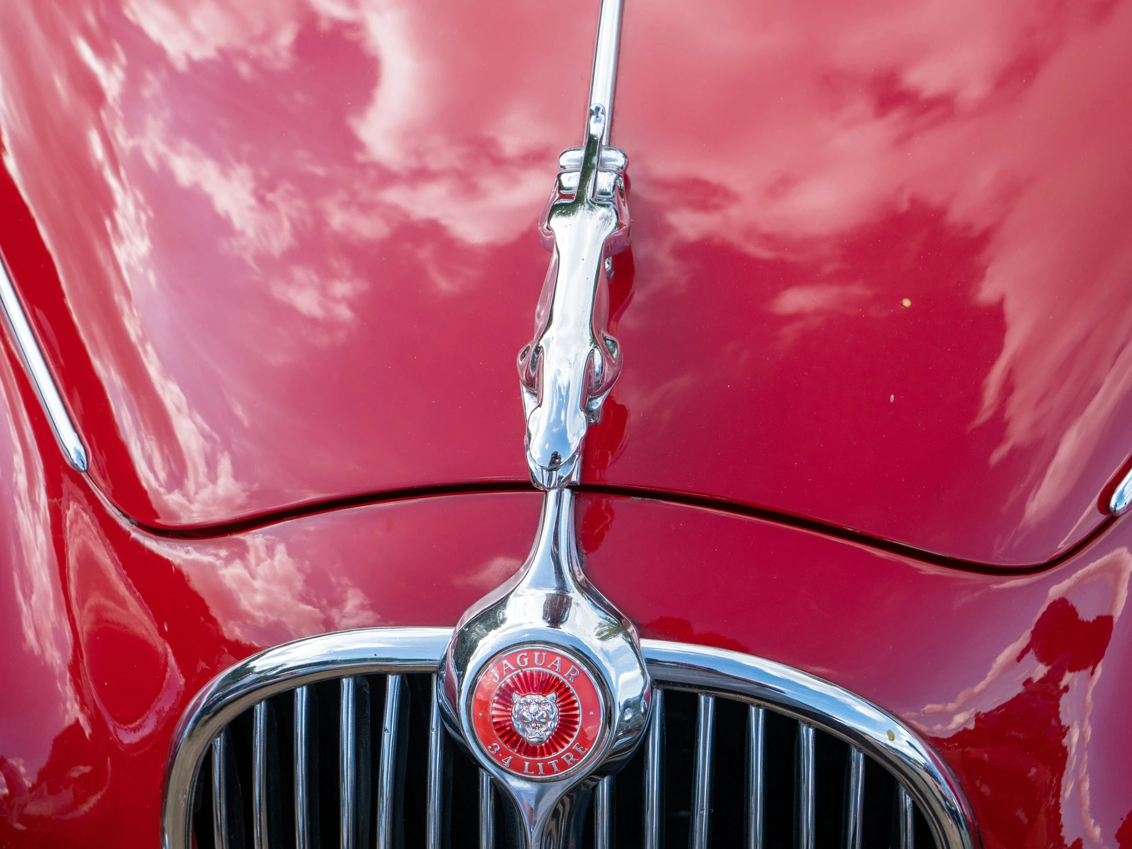 an old classic red car that is being displayed