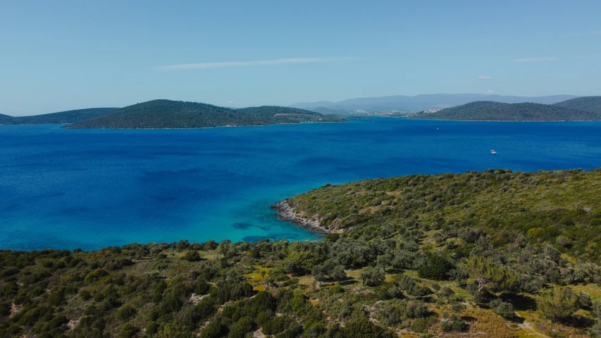 an island surrounded by water and mountains