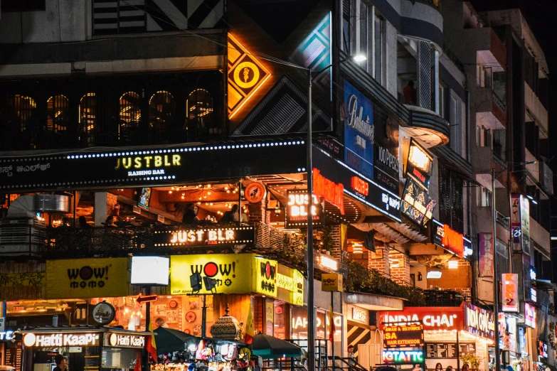 an assortment of street lights and stores at night