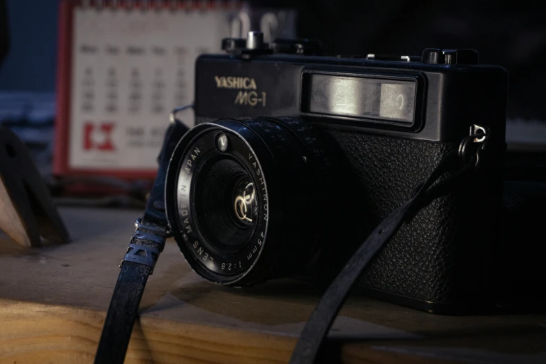 an old po camera next to a black strap