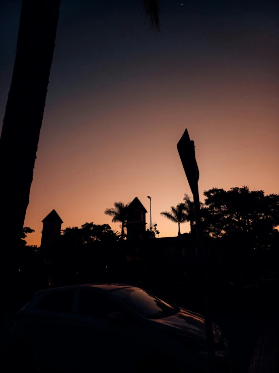 silhouettes of a few buildings with trees near a building