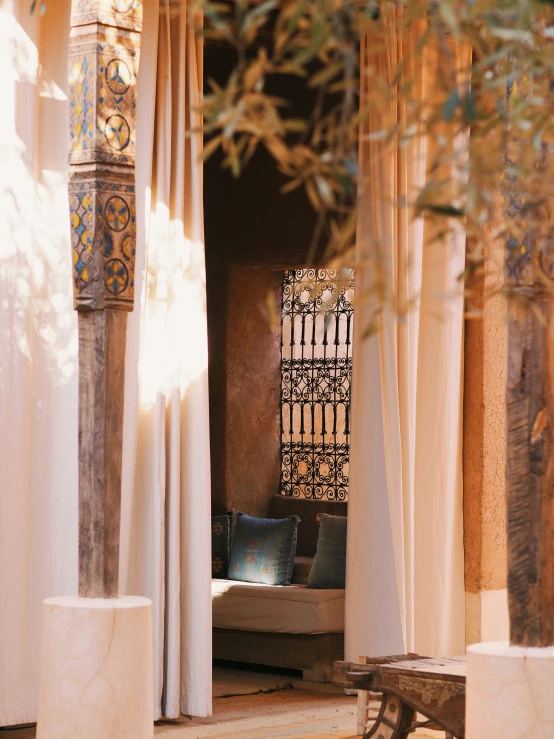 a seating area between two pillars in front of a gate