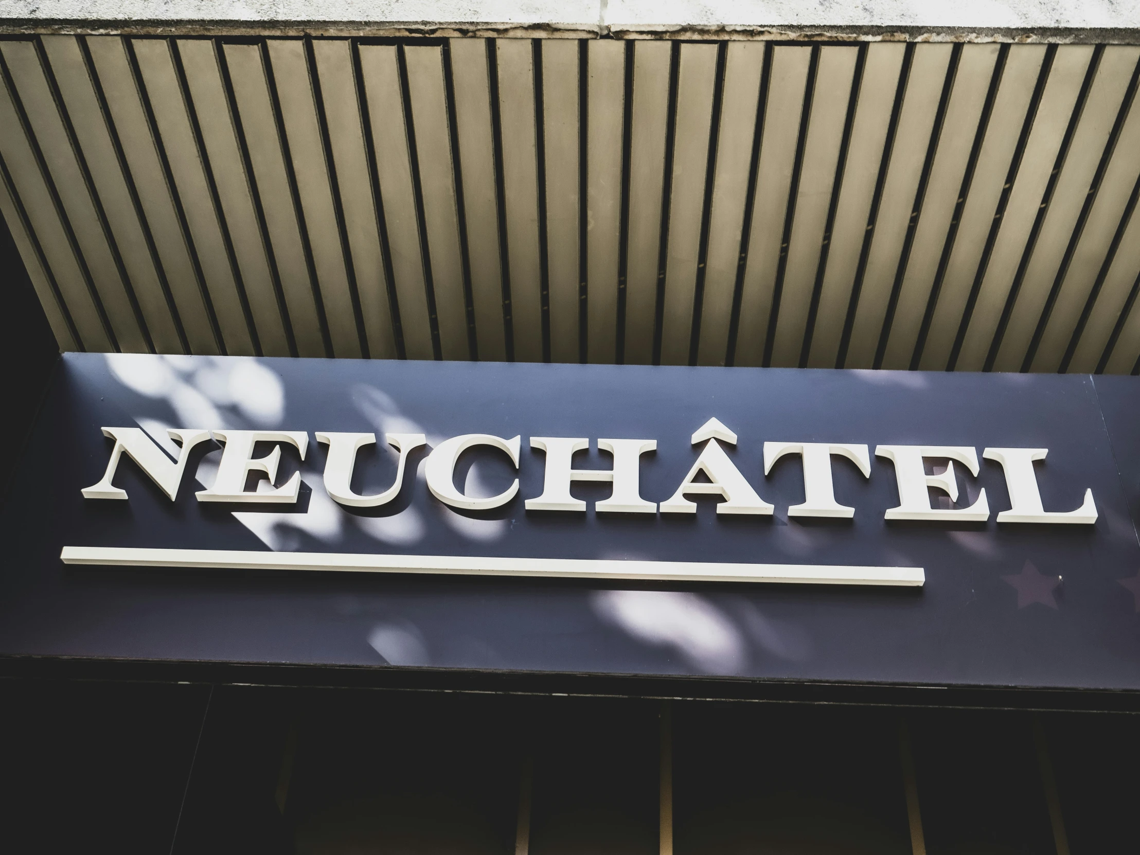 the name of the company neuchatel over the entrance