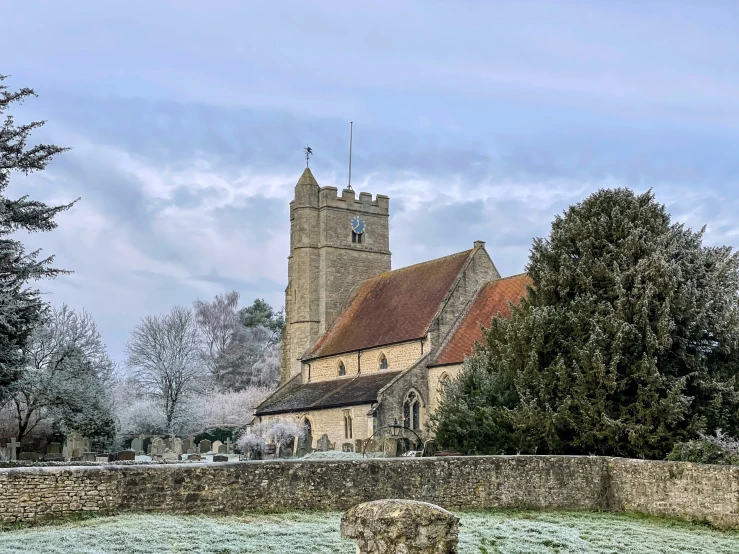 a church with a clock tower next to trees