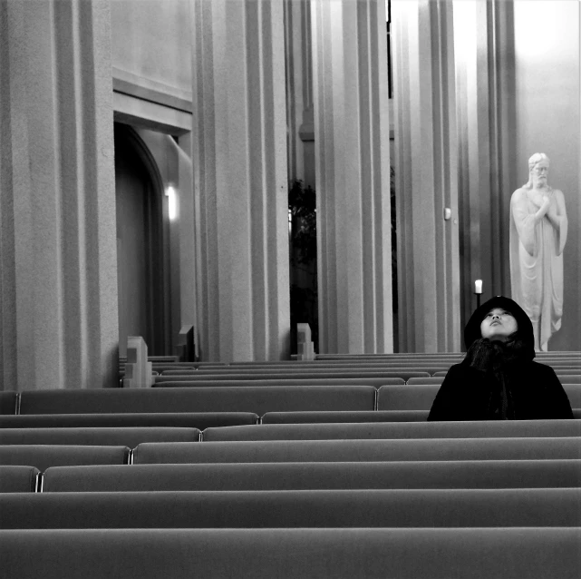 a woman is sitting down in a church
