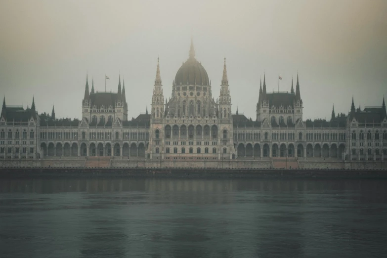 the building is old and beautiful next to the water