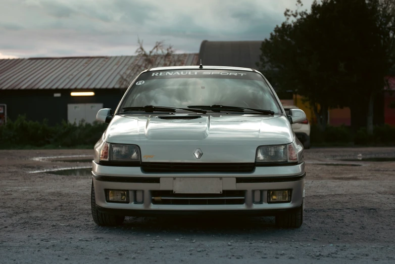 the front view of a small car on an open lot