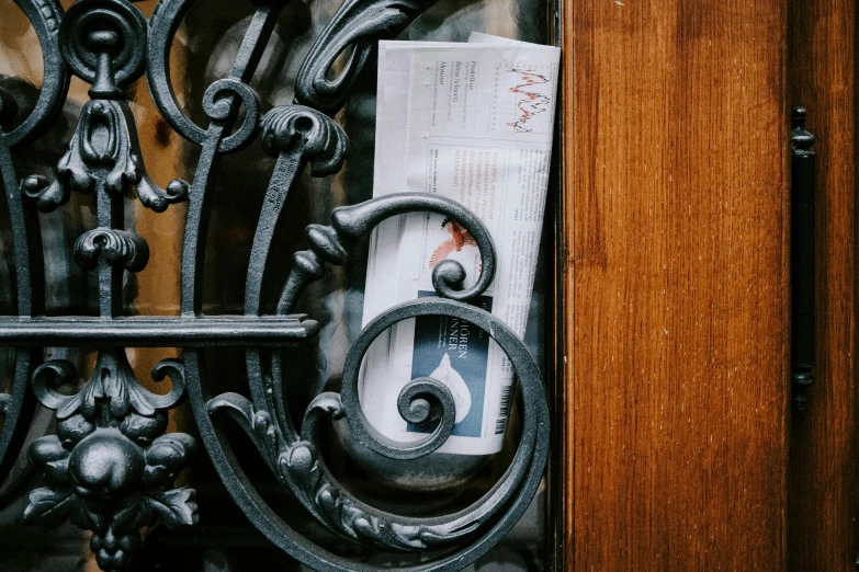 an iron door with some paper and an iron handle on it