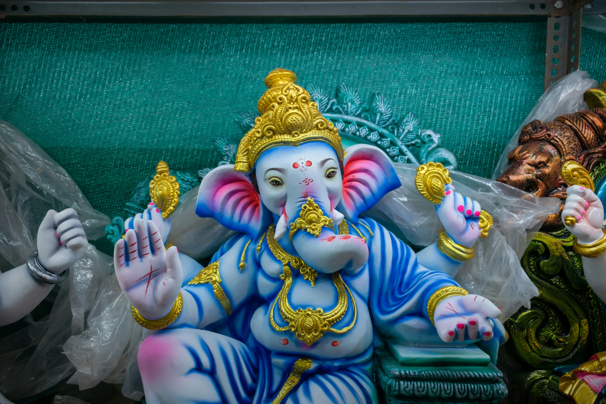 a statue of a god and other religious figures in a shop window