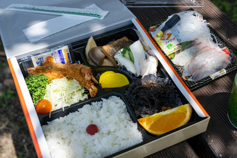 an open lunch box full of food on a table