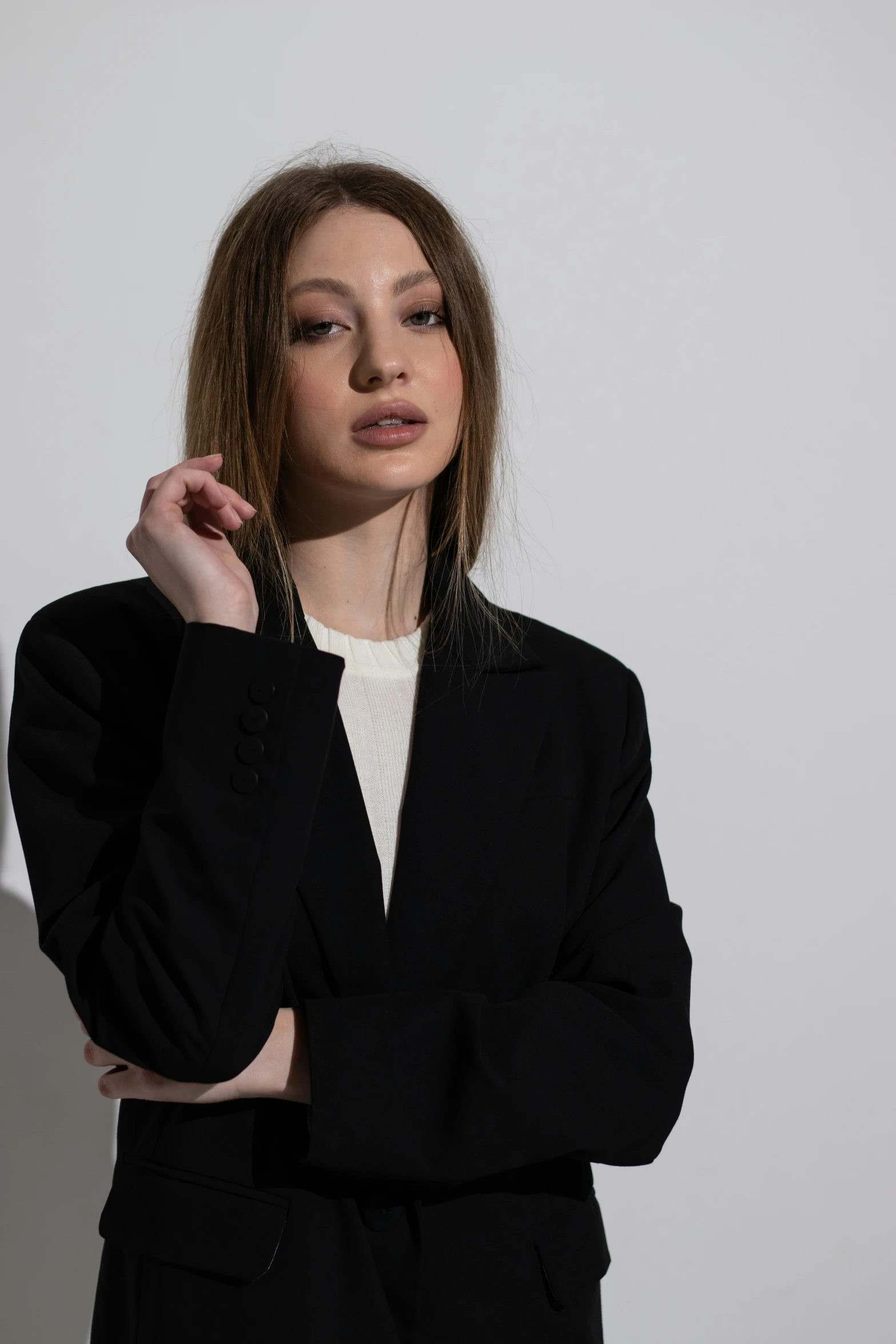 a girl posing with her arm on her shoulder