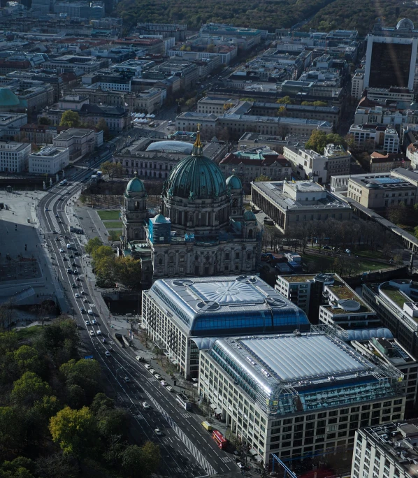 aerial view of an intersection with cars, buildings and buses