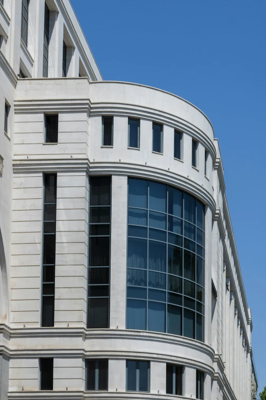 the top of a white building with many windows