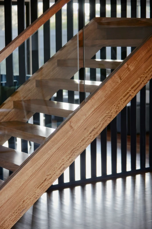 a metal and wood banister with glass sides