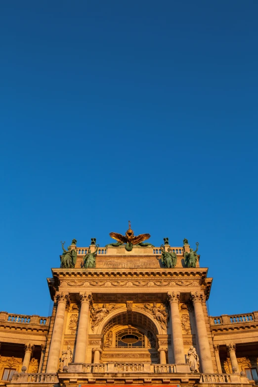 the view from below of a tower, a clock, and a building