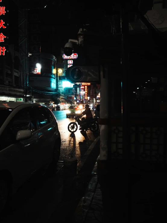 people walking along the street at night in a city