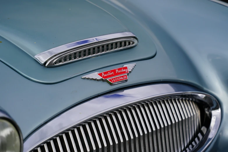 an emblem is seen on the front of an old car