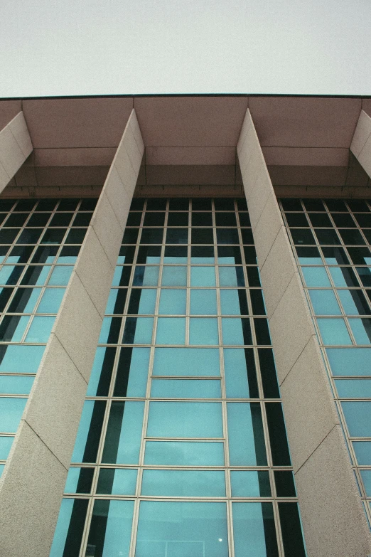 the side of a building with windows and an airplane