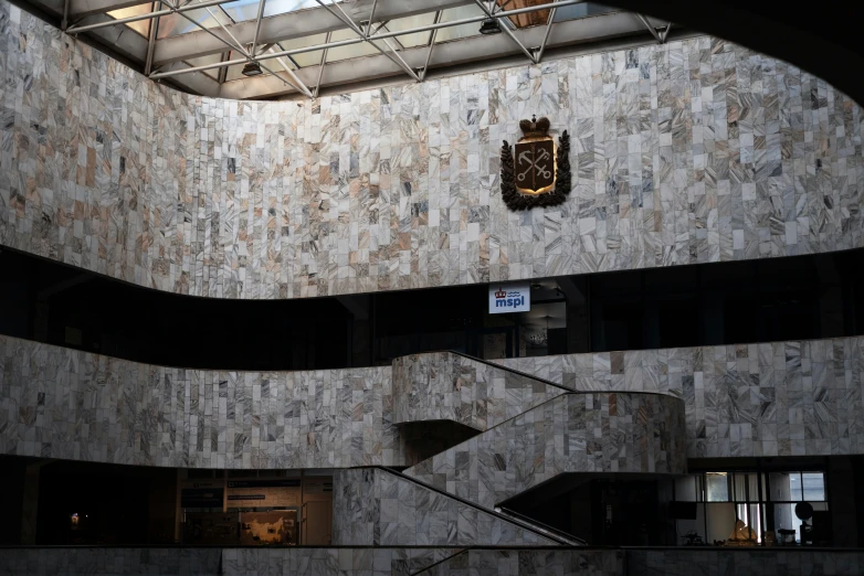 a very large concrete staircase with a clock