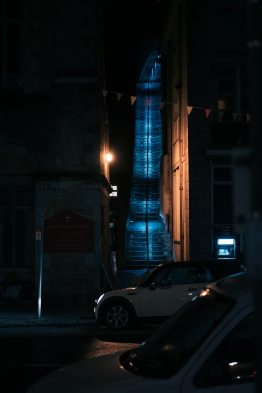 a car parked next to a tall clock tower