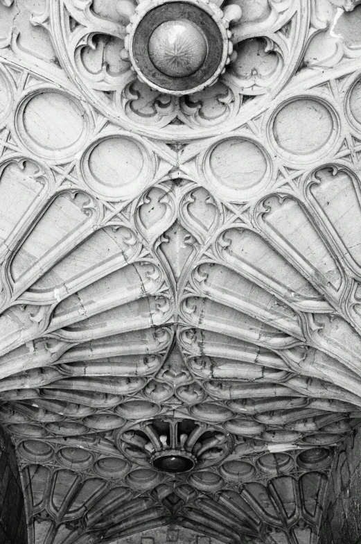 the ceiling of a large building that has many circular designs