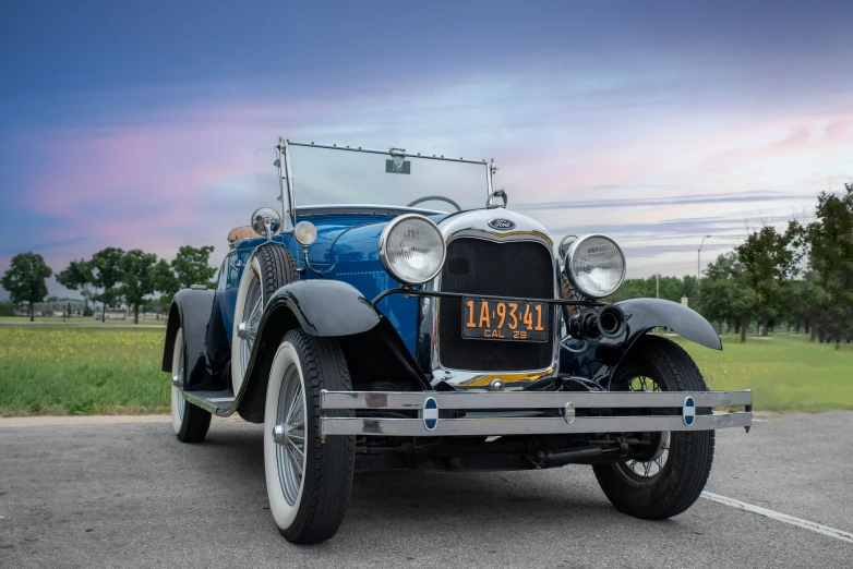 an antique car is parked in a lot