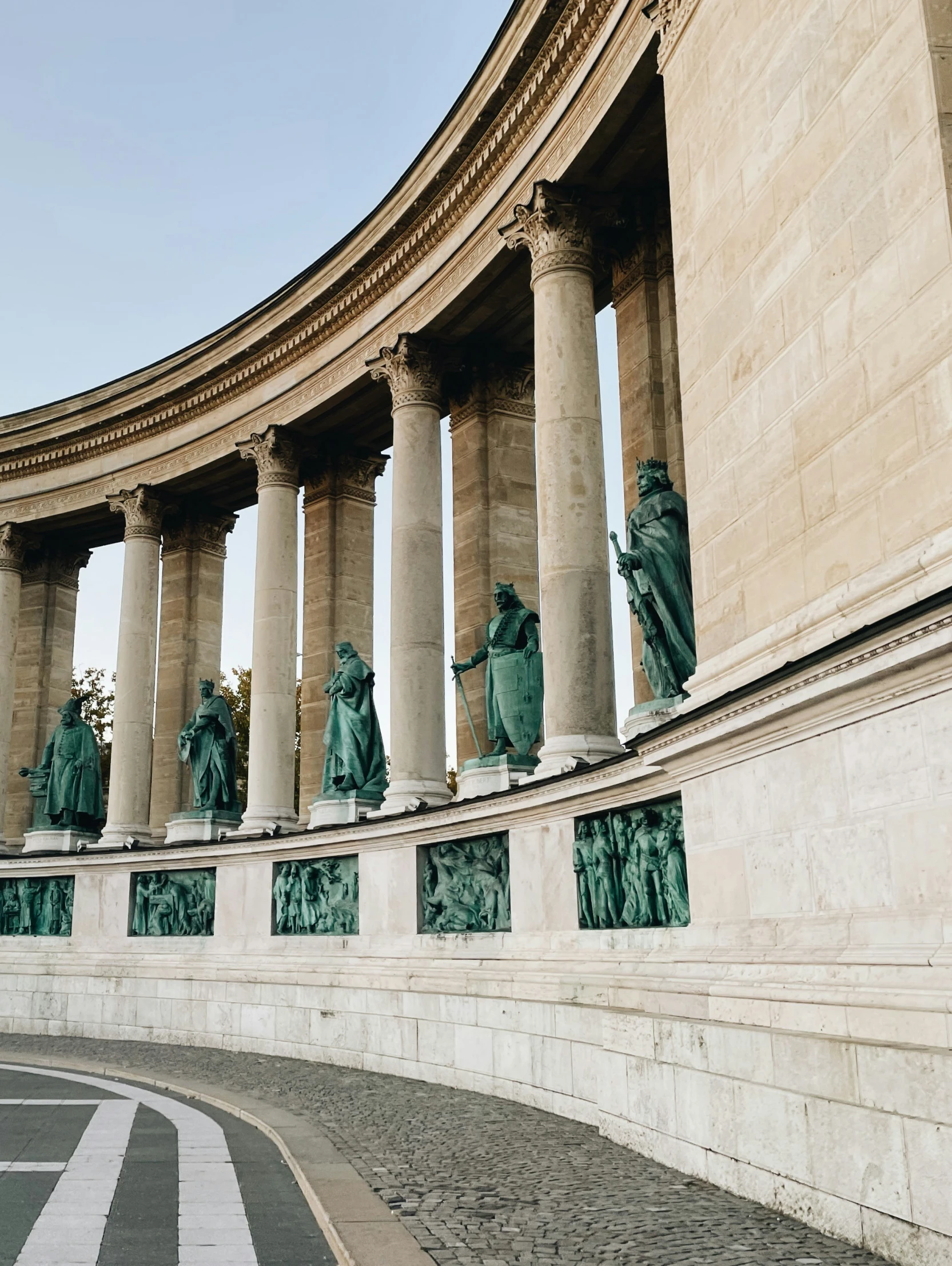 a group of statues on either side of a building