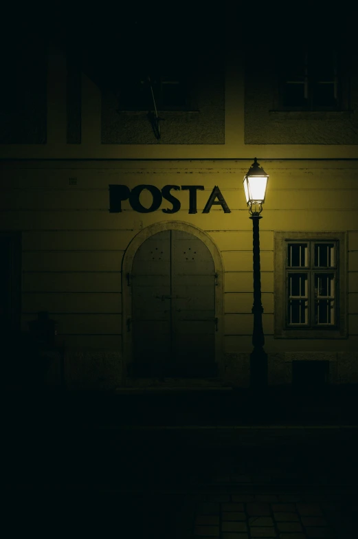 a lamp on a post in front of a building