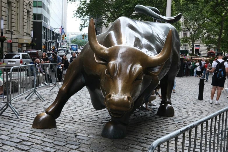 a bull statue on the side of a road