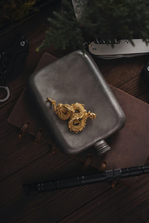 a pair of scissors and a metal case sitting on top of a desk