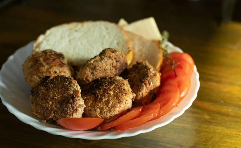 meatballs and tomatoes are on a plate