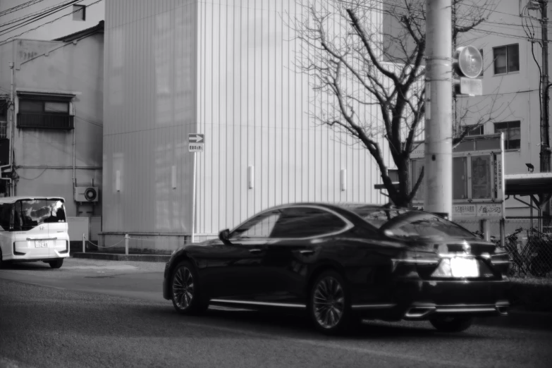 a black car is parked at the curb