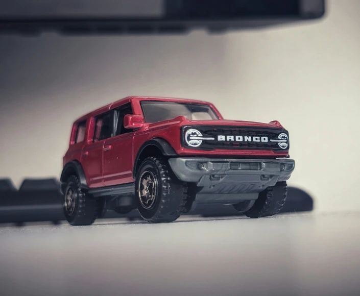 a model red ford f - 150 truck that has been set up on the table