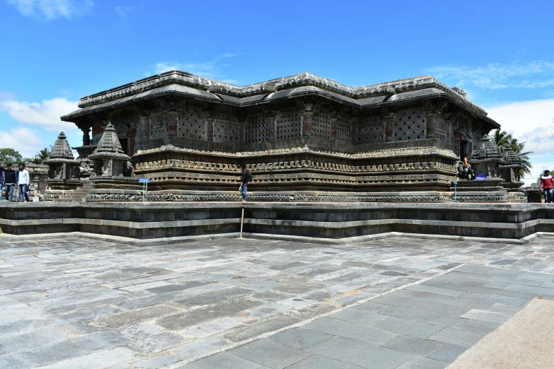 several statues at the base of a temple