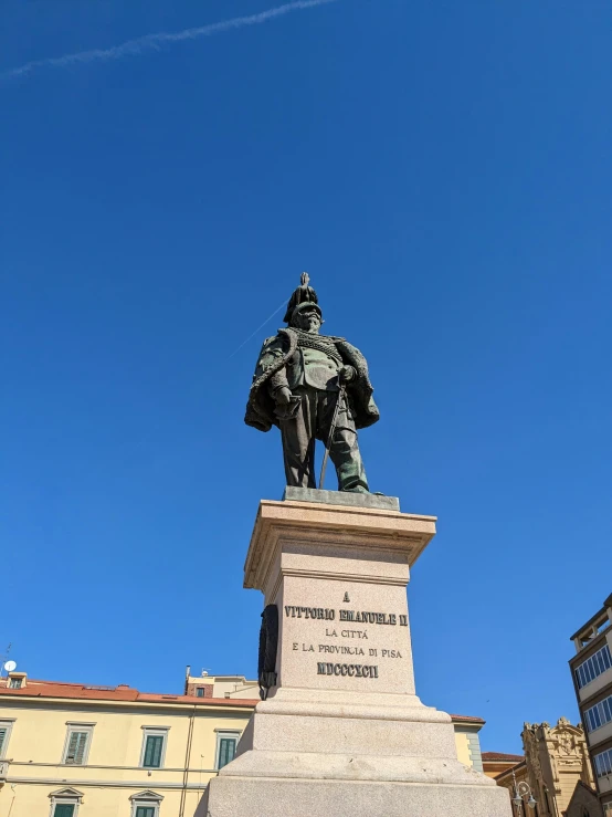 the statue stands near several buildings and has it's picture taken