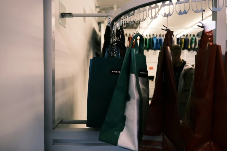 a large long coat rack with bags on top