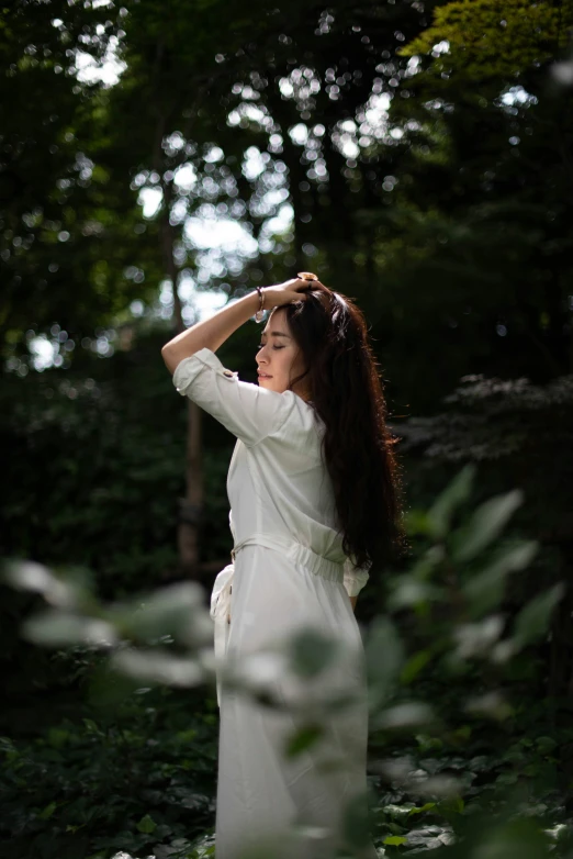 a young woman posing in the woods by herself