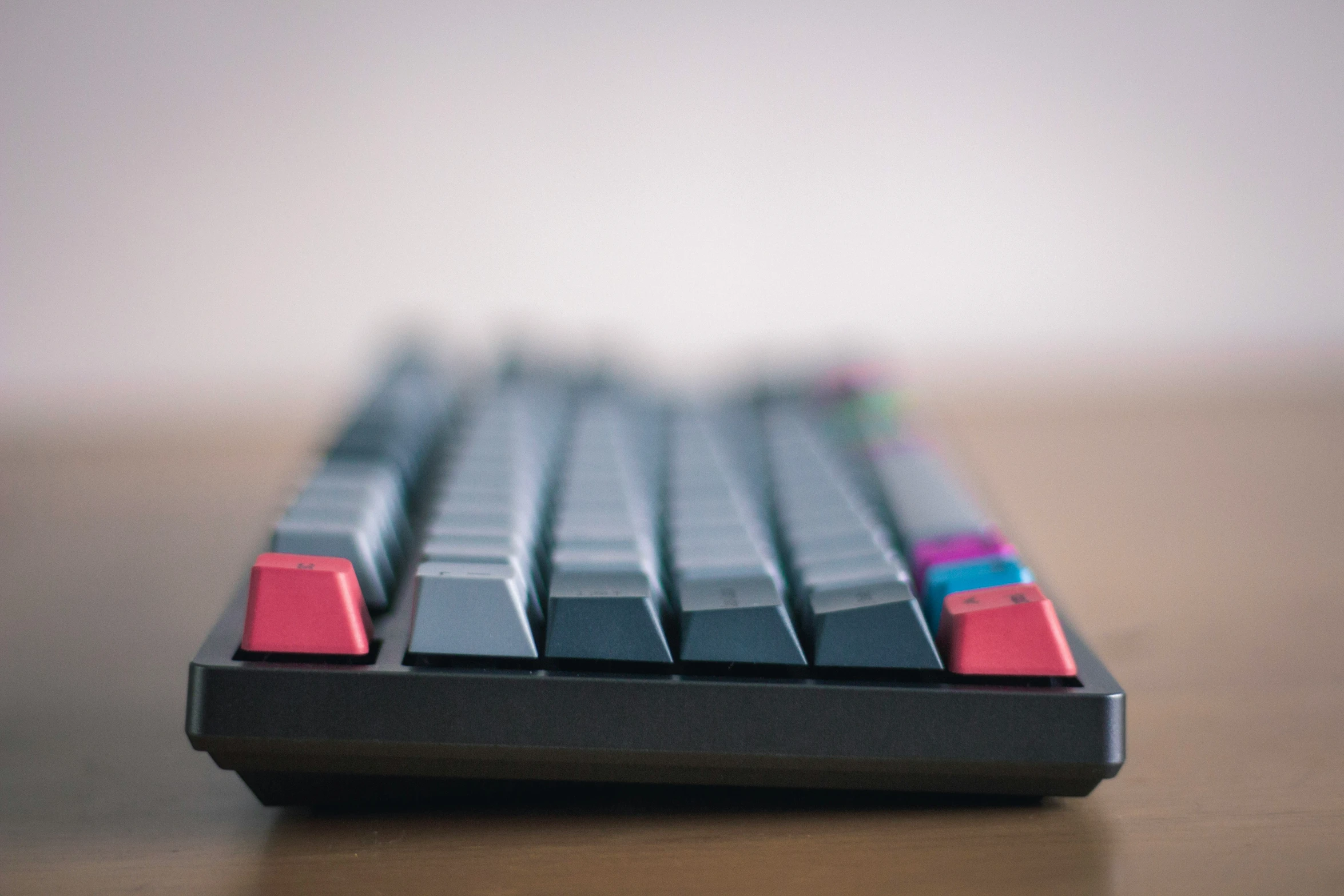 an old computer keyboard has a colorful strip on it