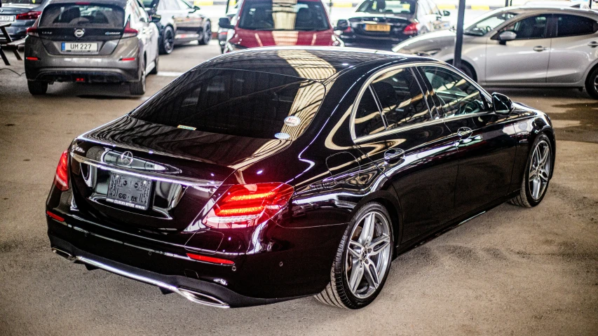 the back view of a black car with its trunk open