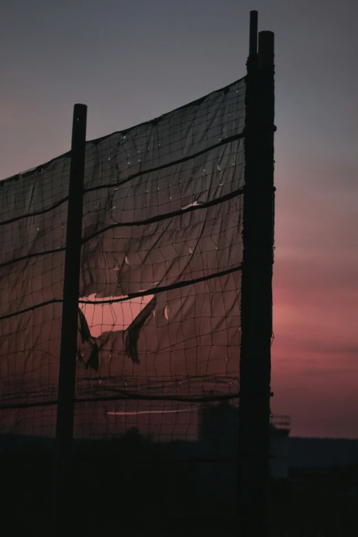 a large piece of cloth hanging on the side of a fence