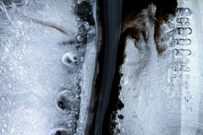 the view from above of snow covered ground with footprints