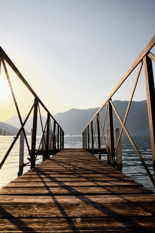 a long dock with railings extending into the water