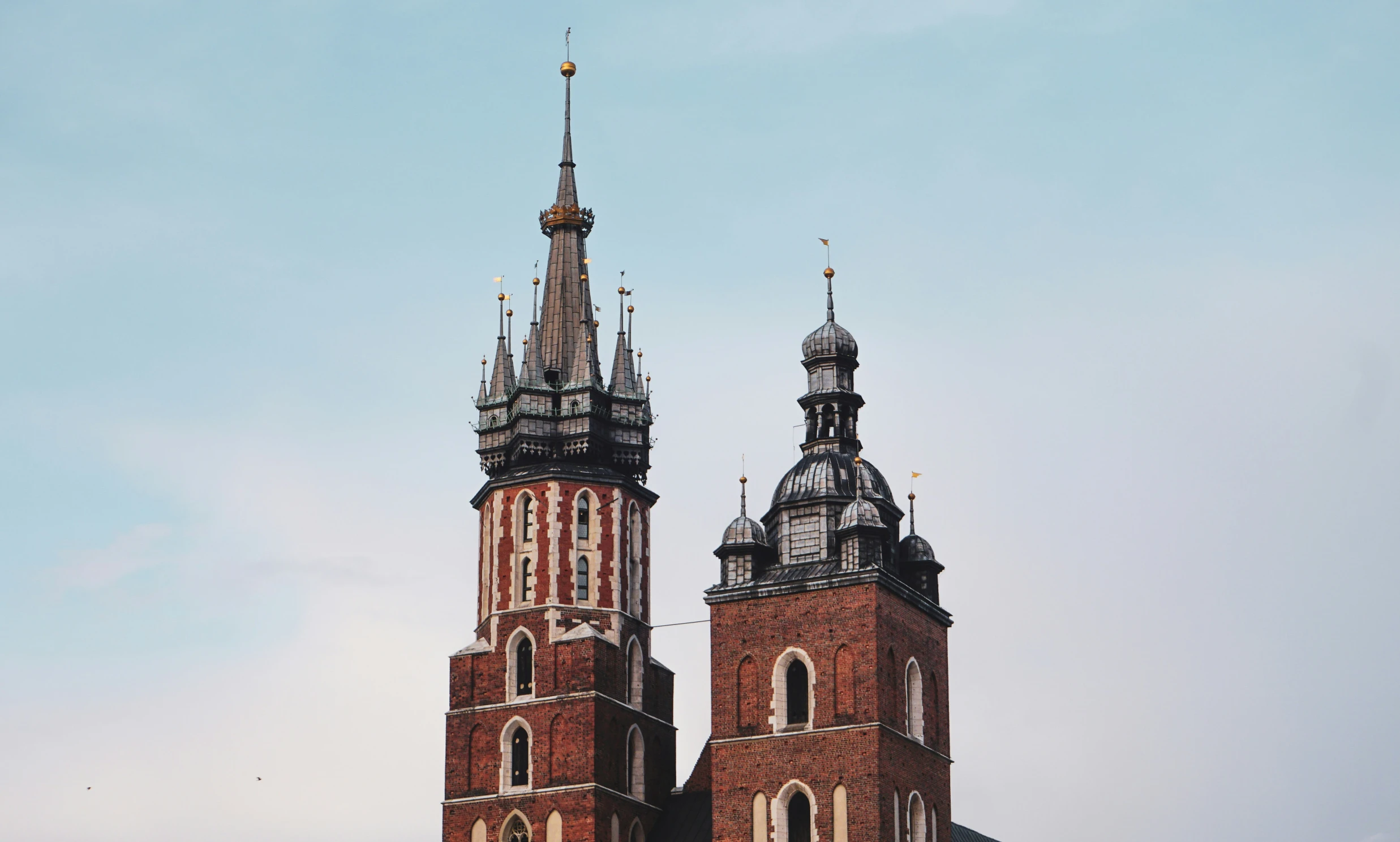 two very tall towers with clocks on them