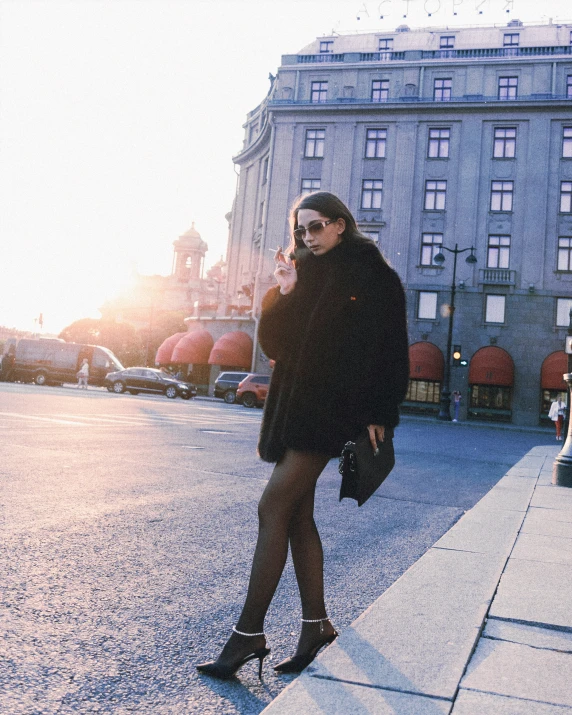 a woman standing on the side walk