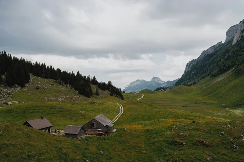 two small cabin like structures in a mountain valley