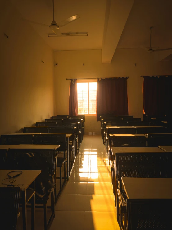 a classroom with rows of desks with chairs at each