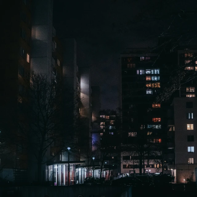 night scene of lit - up buildings in a city at night