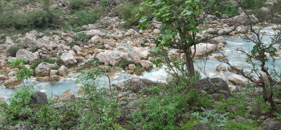 the river is rushing down a rocky cliff